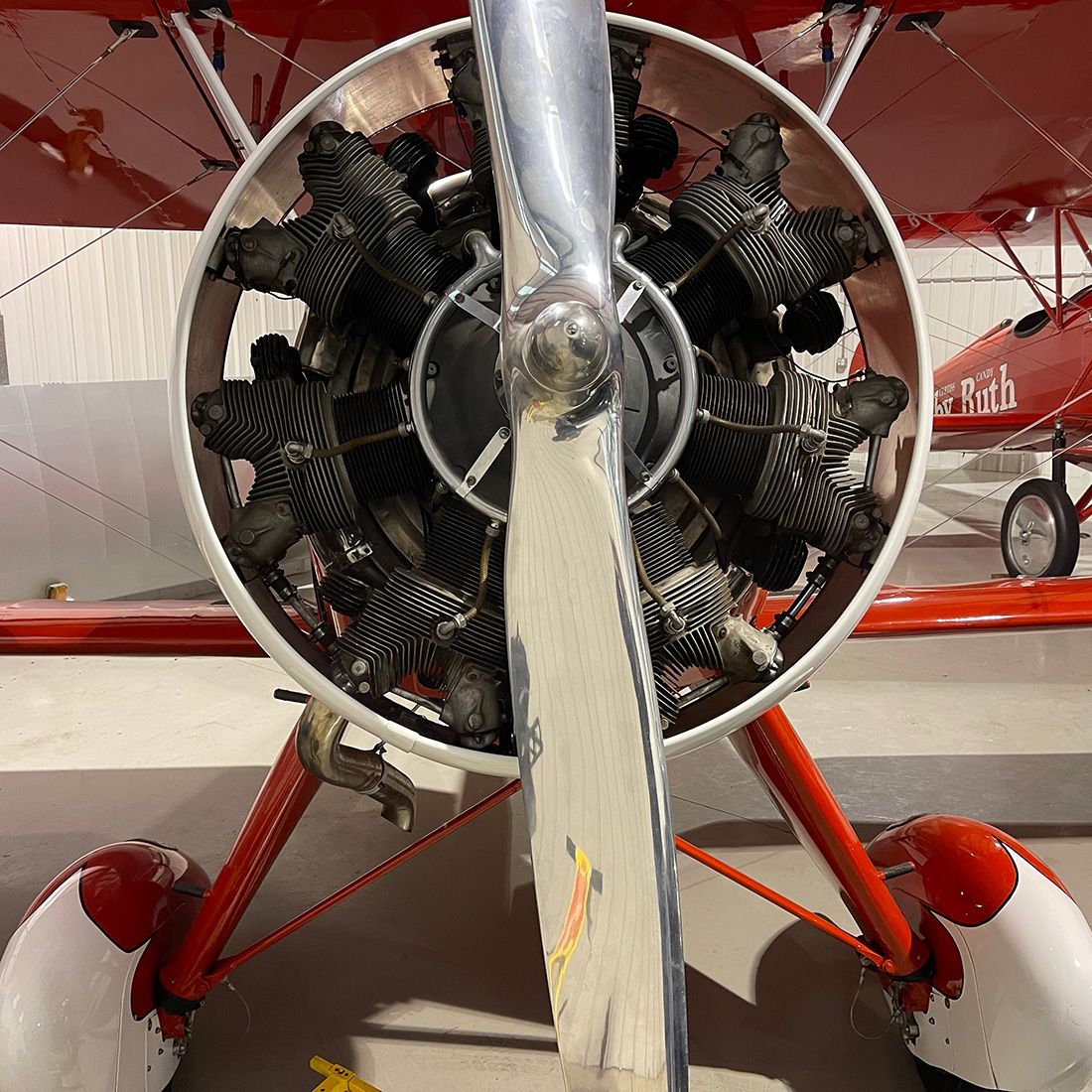 close up of texaco 17 plane from the front. wheel pants and prop are prominent