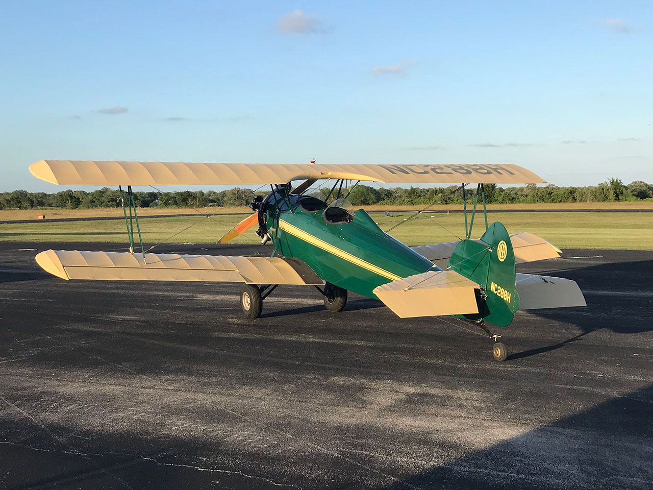 Green and yellow Fleet biplane sitting on taxiway