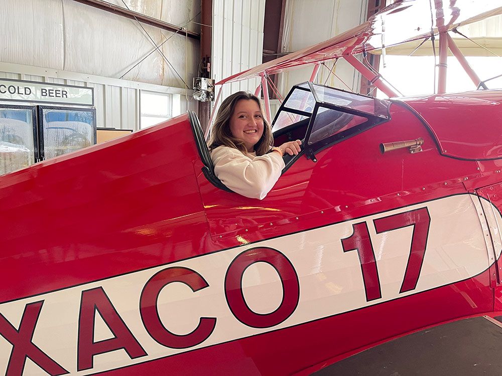 teenage girl smiling from cockpit of the texaco 17