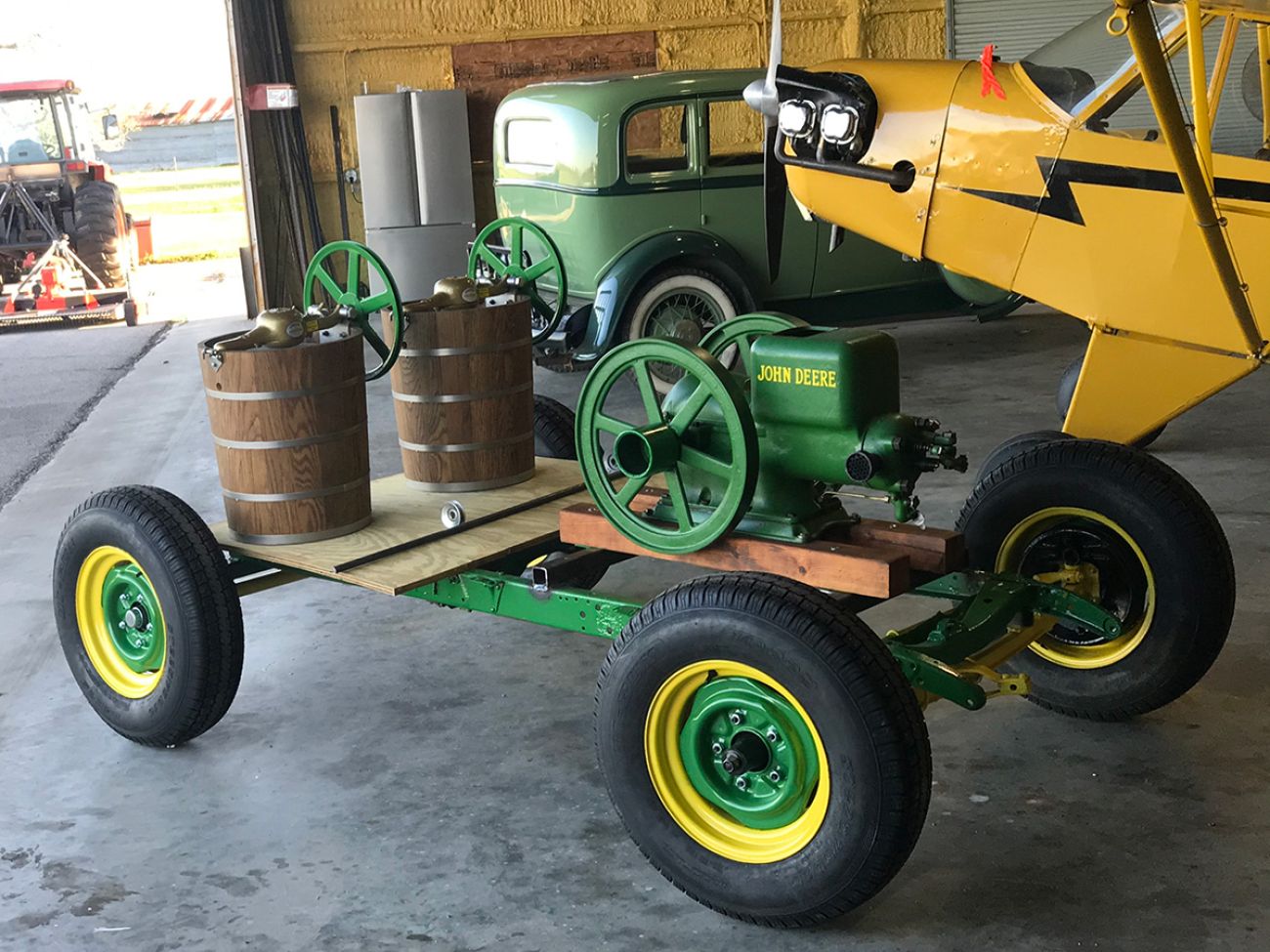 john-deere green engine mounted on a trailer with two ice cream churns hooked up to it